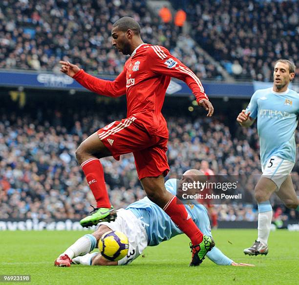 Ryan Babel of Liverpool competes with Nigel de Jong of Manchester City during the Barclays Premier League match between Manchester City and Liverpool...