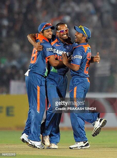 Indian cricketers Dinesh Karthik and Suresh Raina congratulate teammate Yusuf Pathan for the wicket of South Africa cricketer Johan Botha during the...