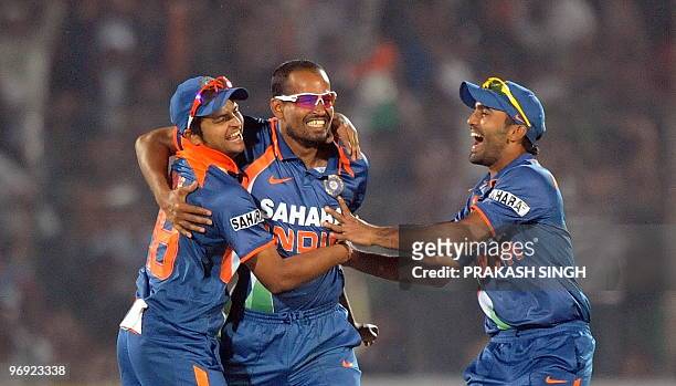 Indian cricketers Dinesh Karthik and Suresh Raina congratulate teammate Yusuf Pathan for the wicket of South Africa cricketer Johan Botha during the...