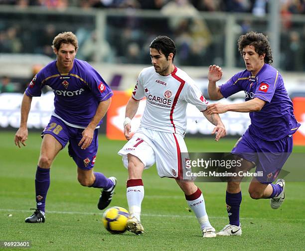 Mario Ariel Bolatti and Stevan Jovetic of ACF Fiorentina battle for the ball against Nico Pulzetti of AS Livorno during the Serie A match between ACF...