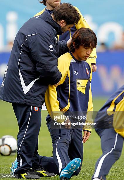 Shunsuke Nakamura of Espanyol is embraced by his kitman during the pre-match warm-up before the start of the La Liga match between Malaga and...