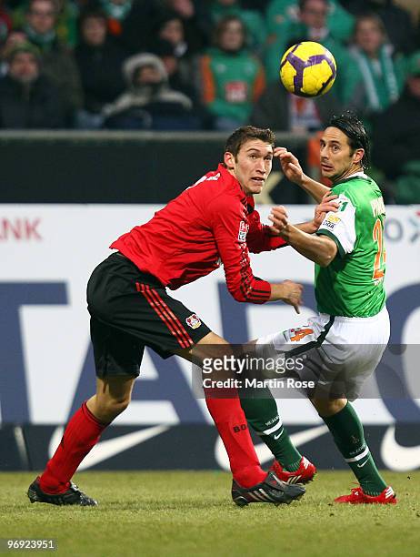 Claudio Pizarro of Bremen and Stefan Reinartz of Leverkusen compete for the ball during the Bundesliga match between Werder Bremen and Bayer...