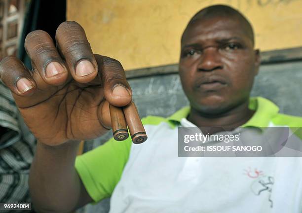 Coulibaly Pie shows bullets reportedly used by Ivorian policemen who shot his 18-year-old son during demonstrations in the western town of Gagnoa on...