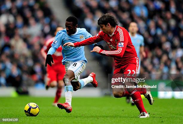 Shaun Wright-Phillips battles with Emiliano Insua of Liverpool during the Barclays Premier League match between Manchester City and Liverpool at City...