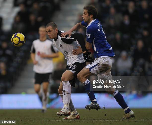 Bobby Zamora of Fulham contests Roger Johnson of Birmingham during the Barclays Premier League match between Fulham and Birmingham City at Craven...