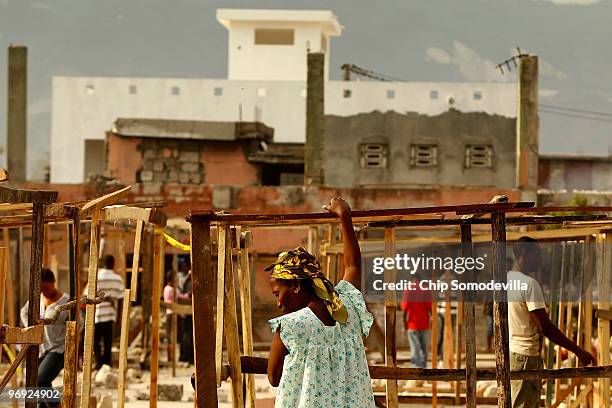 Hatians begin to build shacks on a concrete slab where the collapsed Marche Tete Boeuf market once stood along the Grand Rue, one of the oldest...