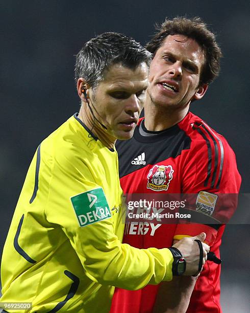 Manuel Friedrich of Leverkusen argues with referee Michael Weiner during the Bundesliga match between Werder Bremen and Bayer Leverkusen at the Weser...