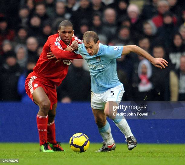 Ryan Babel of Liverpool goes up with Pablo Zabaleta of Manchester City during the Barclays Premier League match between Manchester City and Liverpool...