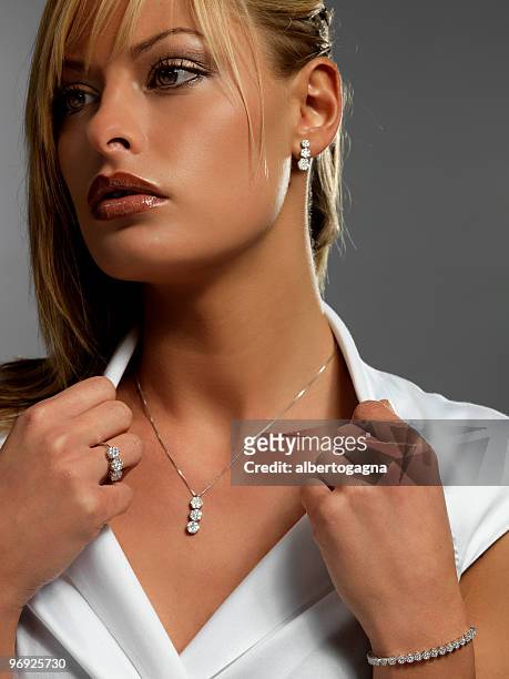 close-up of girl staring at distance wearing diamond jewelry - diamond necklace stock pictures, royalty-free photos & images
