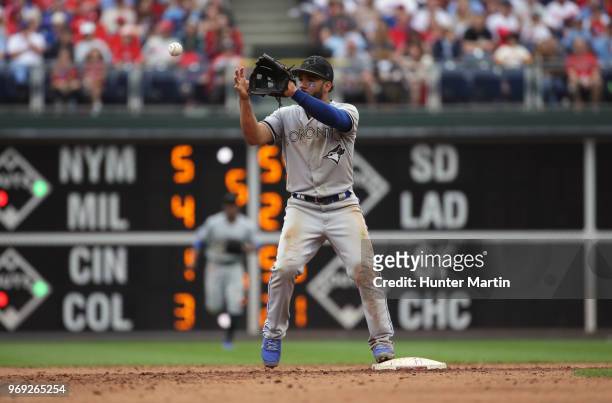 Devon Travis of the Toronto Blue Jays catches the ball during a game against the Philadelphia Phillies at Citizens Bank Park on May 27, 2018 in...