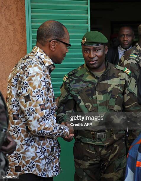 Mohamed Ibn Chambas , head of the 15-nation regional economic bloc ECOWAS shakes hands on February 21, 2010 with Colonel Djibrilla Hamidou Hima, one...