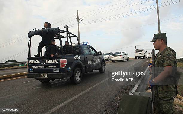 Military and Mexican Federal Police personnel patrol the freeway in the Riviera Maya, Quintana Roo state, Mexico on February 21 prior to the arrival...