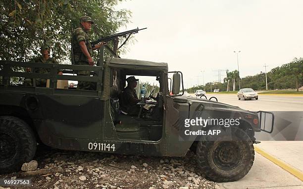 Military and Mexican Federal Police personnel patrol the freeway in the Riviera Maya, Quintana Roo state, Mexico on February 21 prior to the arrival...