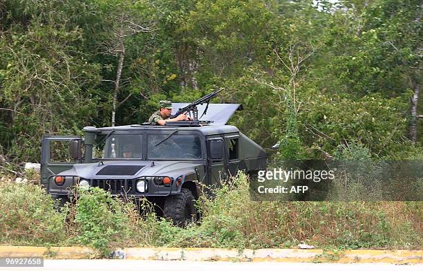 Military personnel patrol the freeway in the Riviera Maya, Quintana Roo state, Mexico on February 21 prior to the arrival of 34 presidents who will...