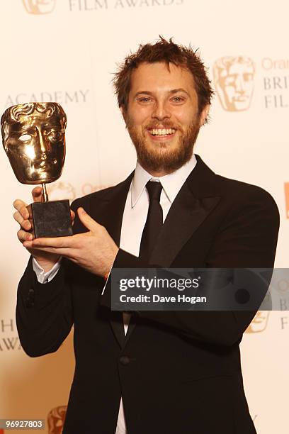 Duncan Jones poses with his best British directoral debut award in front of the winners boards at the Orange British Academy Film Awards held at The...