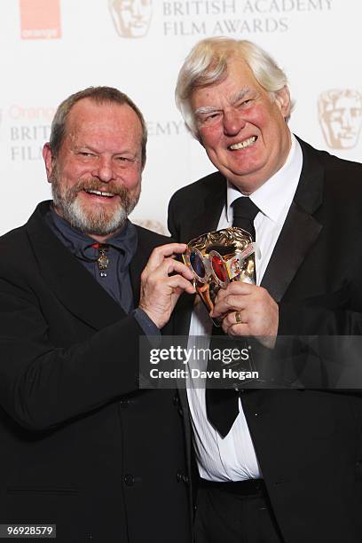 Terry Gilliam poses with Joe Dunton after presenting him with the outstanding contribution to British cinema award in front of the winners boards at...