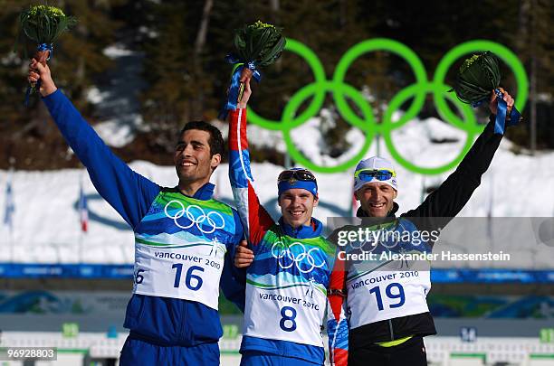 Martin Fourcade of France celebrates winning silver, Evgeny Ustyugov of Russia gold and Pavol Hurajt of Slovakia bronze during the flower ceremony...