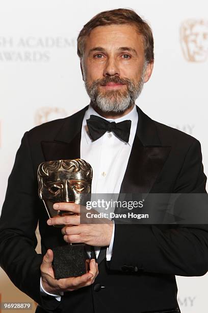 Christoph Waltz poses with his best supporting actor award in front of the winners boards at the Orange British Academy Film Awards held at The Royal...