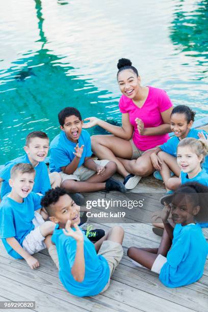 children on field trip at marine park with teacher - portrait of school children and female teacher in field stock pictures, royalty-free photos & images