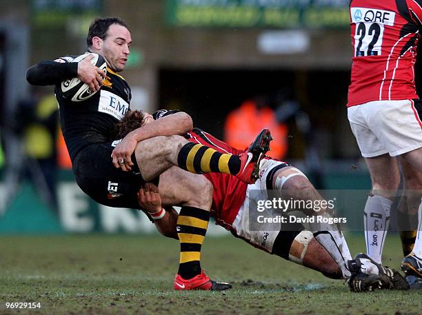 Mark Robinson of Wasps is tackled during the Guinness Premiership match between London Wasps and Saracens at Adams Park on February 21, 2010 in High...