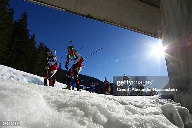 Dominik Landertinger and Simon Eder of Austria lead the pack in the men's biathlon 15 km mass start on day 10 of the 2010 Vancouver Winter Olympics...