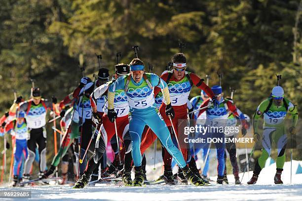 Athletes ski as they compete in the men's Biathlon 15 km mass start final at the Whistler Olympic Park during the Vancouver Winter Olympics on...
