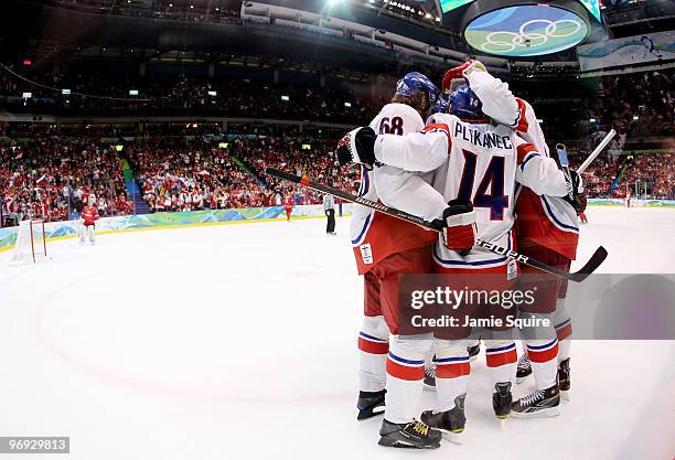 Players from the Czech Republic celebrate with Tomas Plekanec after he scored a first period goal as goalie Evgeni Nabokov of Russia looks on...