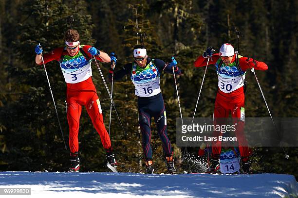 Emil Hegle Svendsen of Norway, Martin Fourcade of France and Halvard Hanevold of Norway compete in the men's biathlon 15 km mass start on day 10 of...