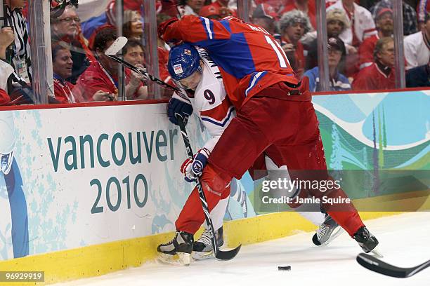 Milan Michalek of Czech Republic battles for the puck with Evgeni Malkin of Russia during the ice hockey men's preliminary game between Russia and...