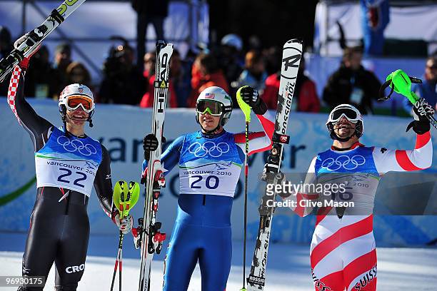 Ivica Kostelic of Croatia, Bode Miller of the United States and Silvan Zurbriggen of Switzerland celebrate at the finish during the Alpine Skiing...