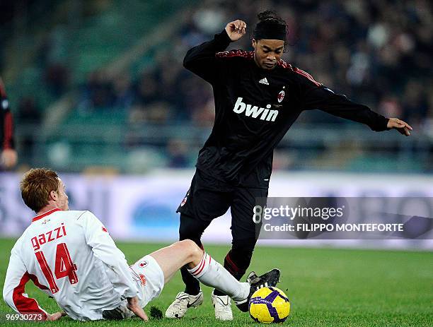 Milan's Brazilian forward Ronaldinho vies with Bari's midfielder Alessandro Gazzi during their Serie A football match in Bari's S. Nicola Stadium on...