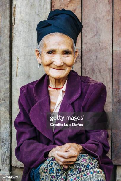 portrait of old laotian woman - laotian culture stock-fotos und bilder