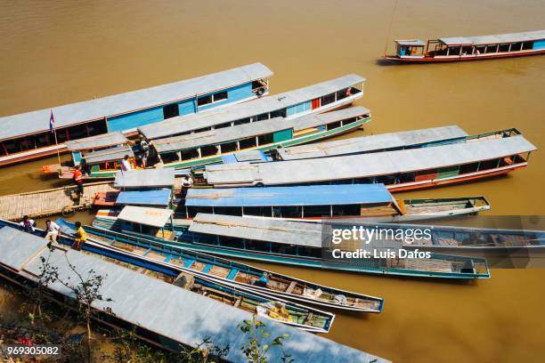 boats moored on the mekong river - laotian culture stock pictures, royalty-free photos & images