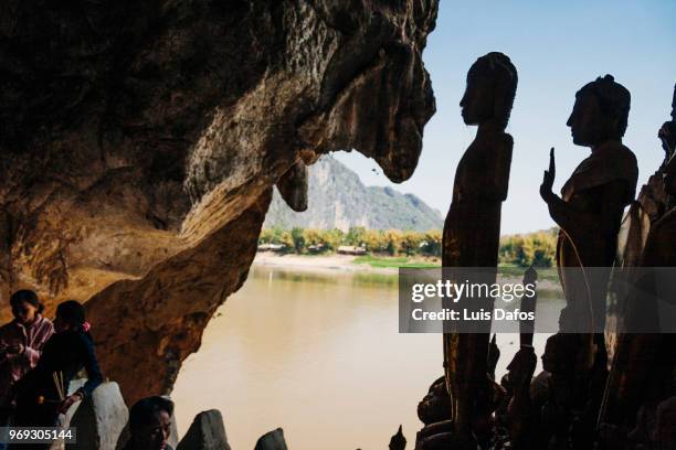 pak ou caves - laotian culture stock pictures, royalty-free photos & images