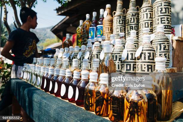 lao-lao rice whisky stall - laotian culture stock pictures, royalty-free photos & images