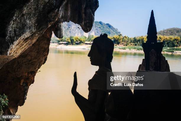 pak ou caves - laotian culture stock pictures, royalty-free photos & images