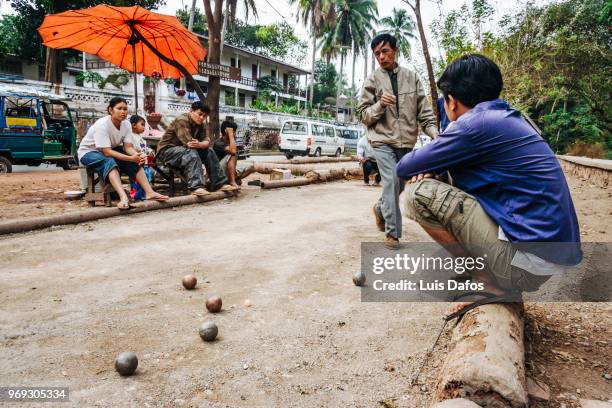 playing petanque in luang prabang - laotian culture stock pictures, royalty-free photos & images