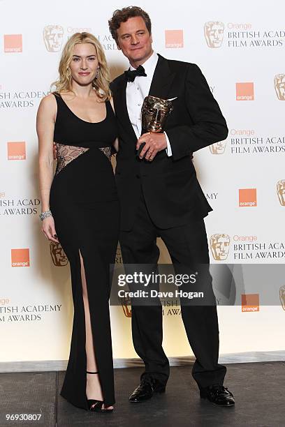 Kate Winslet poses with Colin Firth after presenting him with his best actor award in front of the winners boards at the Orange British Academy Film...