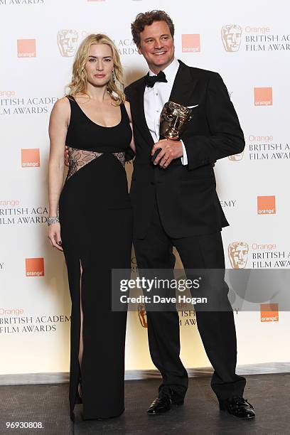 Kate Winslet poses with Colin Firth after presenting him with his best actor award in front of the winners boards at the Orange British Academy Film...