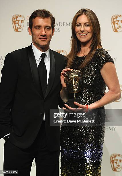 Kathryn Bigelow poses with the Best Director Award presented by Clive Owen during the The Orange British Academy Film Awards 2010, at The Royal Opera...