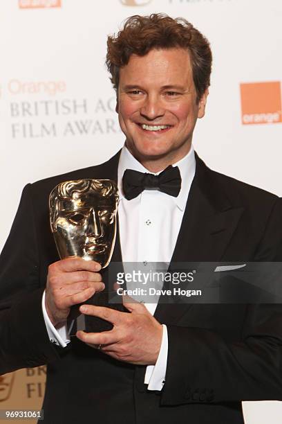 Colin Firth poses with his best actor award in front of the winners boards at the Orange British Academy Film Awards held at The Royal Opera House on...