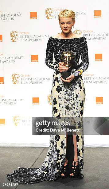 Carey Mulligan poses with the Best Actress Award for An Education during the The Orange British Academy Film Awards 2010, at The Royal Opera House on...