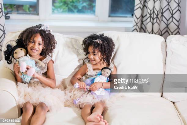 mixed race sisters playing with dolls - american girl doll stock pictures, royalty-free photos & images