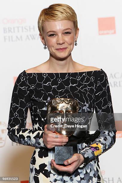 Carey Mulligan poses with her best actress award in front of the winners boards at the Orange British Academy Film Awards held at The Royal Opera...