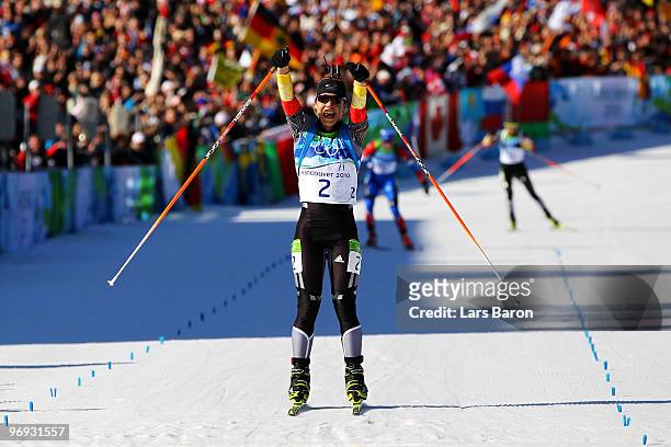 Magdalena Neuner of Germany crosses the line to win gold in the women's biathlon 12.5 km mass start on day 10 of the 2010 Vancouver Winter Olympics...
