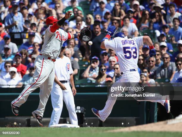 Chris Gimenez of the Chicago Cubs beats the throw to Carlos Santana of the Philadelphia Phillies in the 5th inning at Wrigley Field on June 7, 2018...