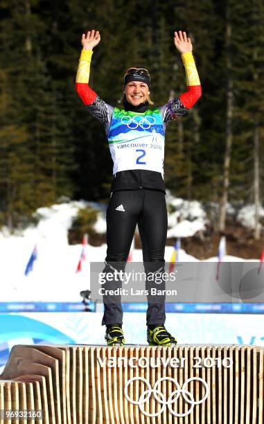 Magdalena Neuner of Germany celebrates gold during the flower ceremony for the women's 12.5 km mass start biathlon on day 10 of the 2010 Vancouver...