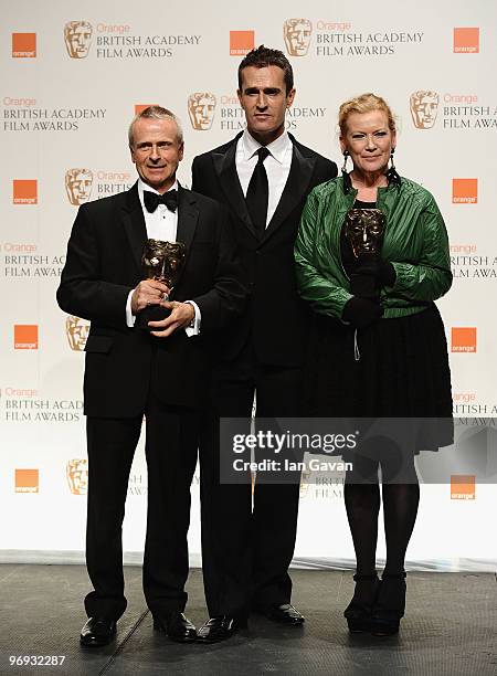 Director Andrea Arnold and producer Nick Laws pose with the Outstanding British Film award for Fish Tank from Rupert Everett during the Orange...