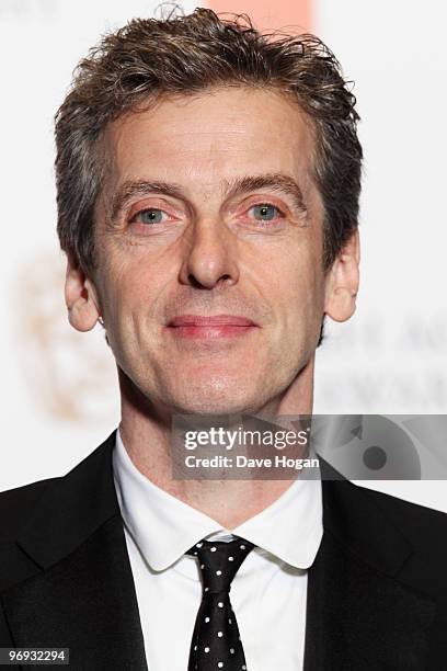 Peter Capaldi poses in front of the winners boards at the Orange British Academy Film Awards held at The Royal Opera House on February 21, 2010 in...