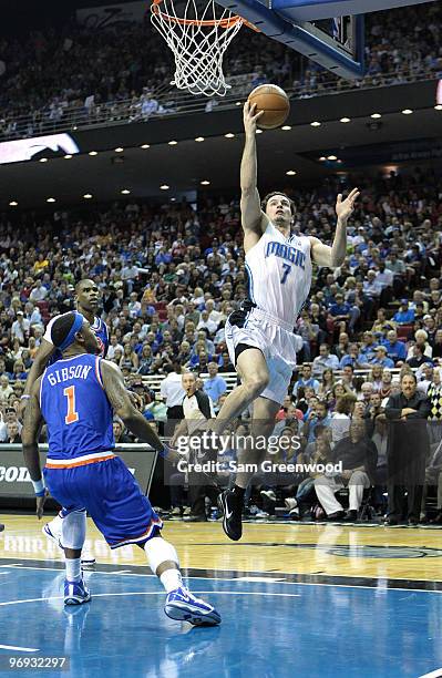 Redick of the Orlando Magic drives to the basket against Daniel Gibson of the Cleveland Cavaliers at Amway Arena on February 21, 2010 in Orlando,...